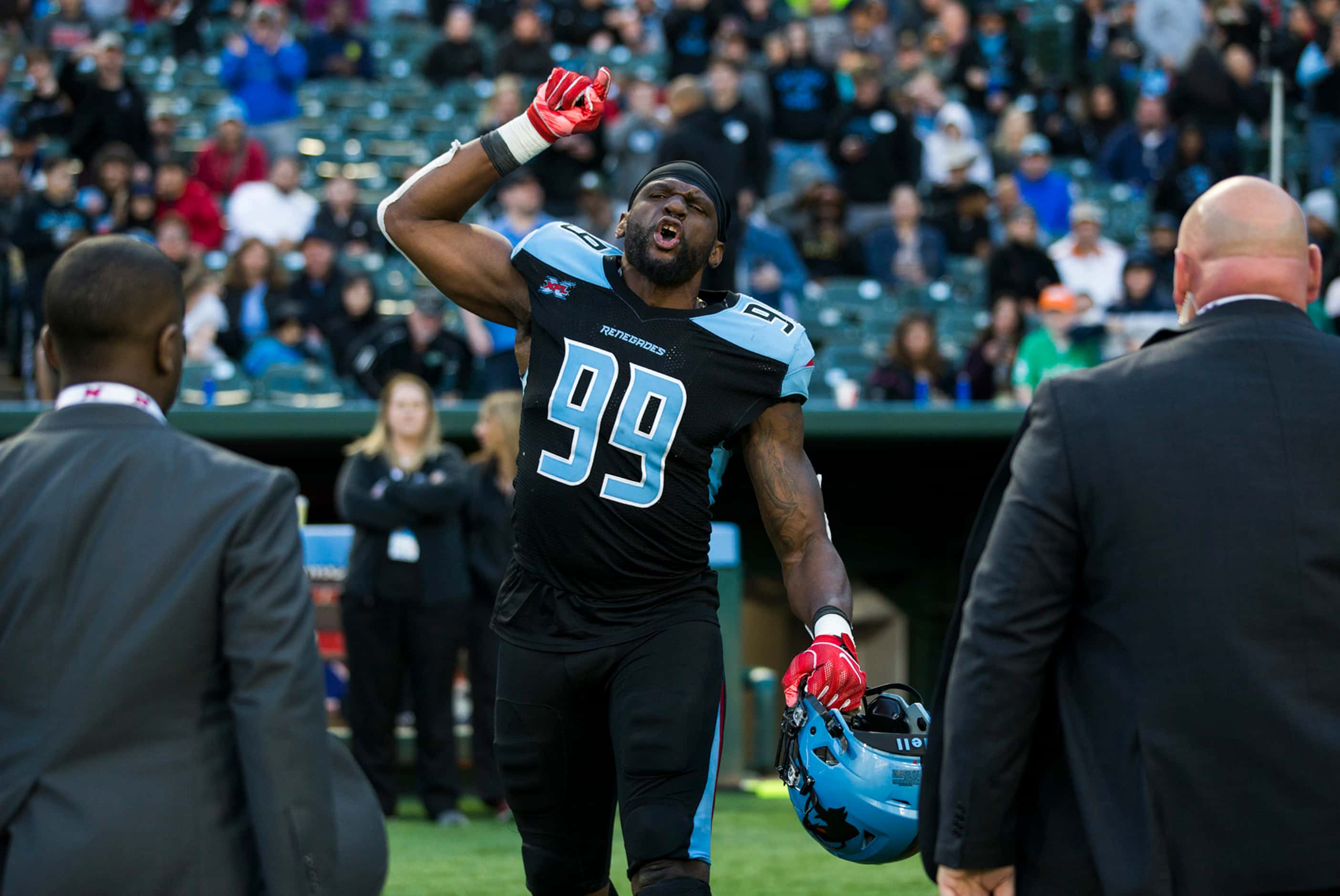 Dallas Renegades defensive end Gerald Rivers (99) yells as he is escorted off the field...