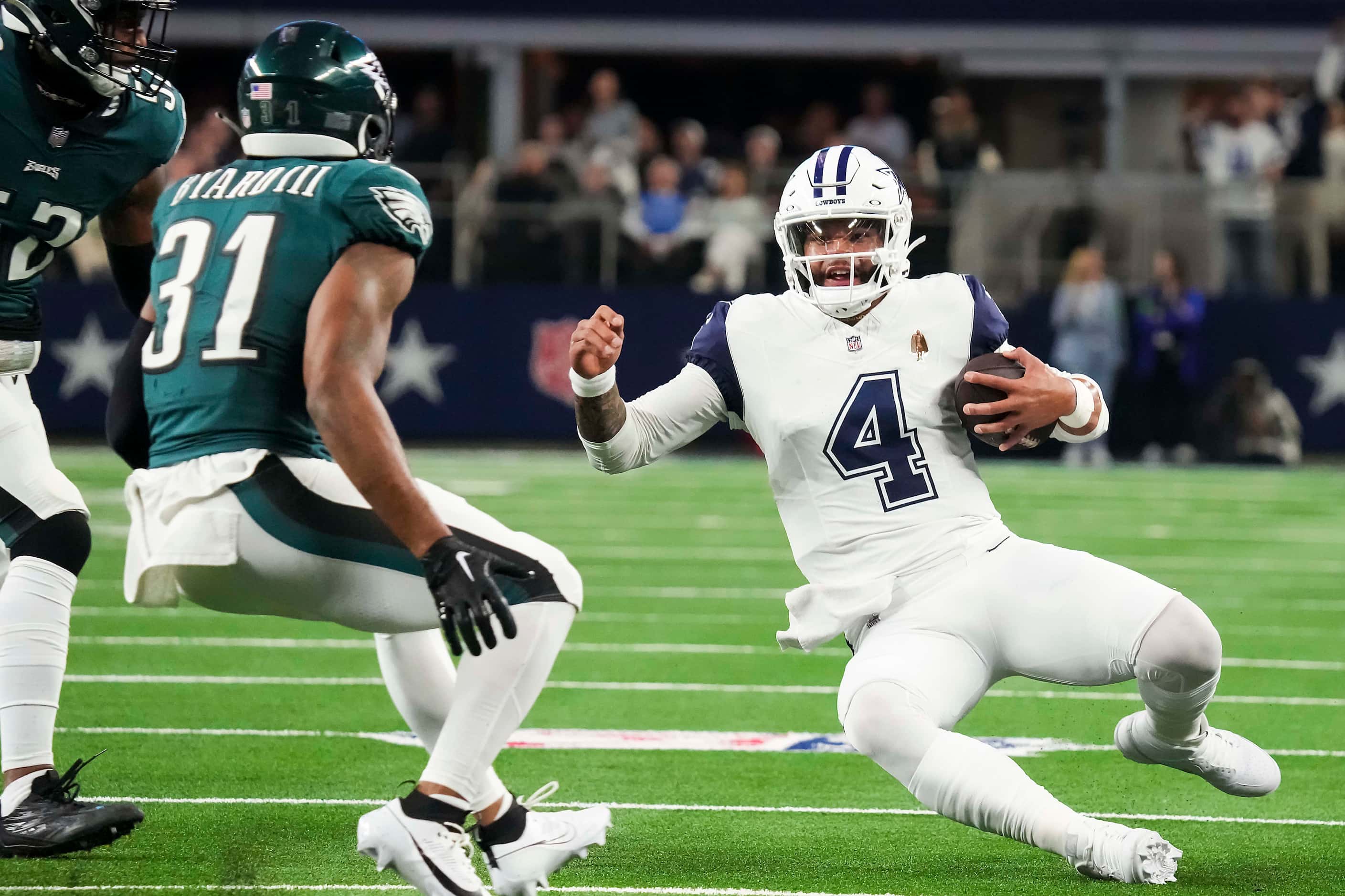 Dallas Cowboys quarterback Dak Prescott (4) slides in front of Philadelphia Eagles safety...