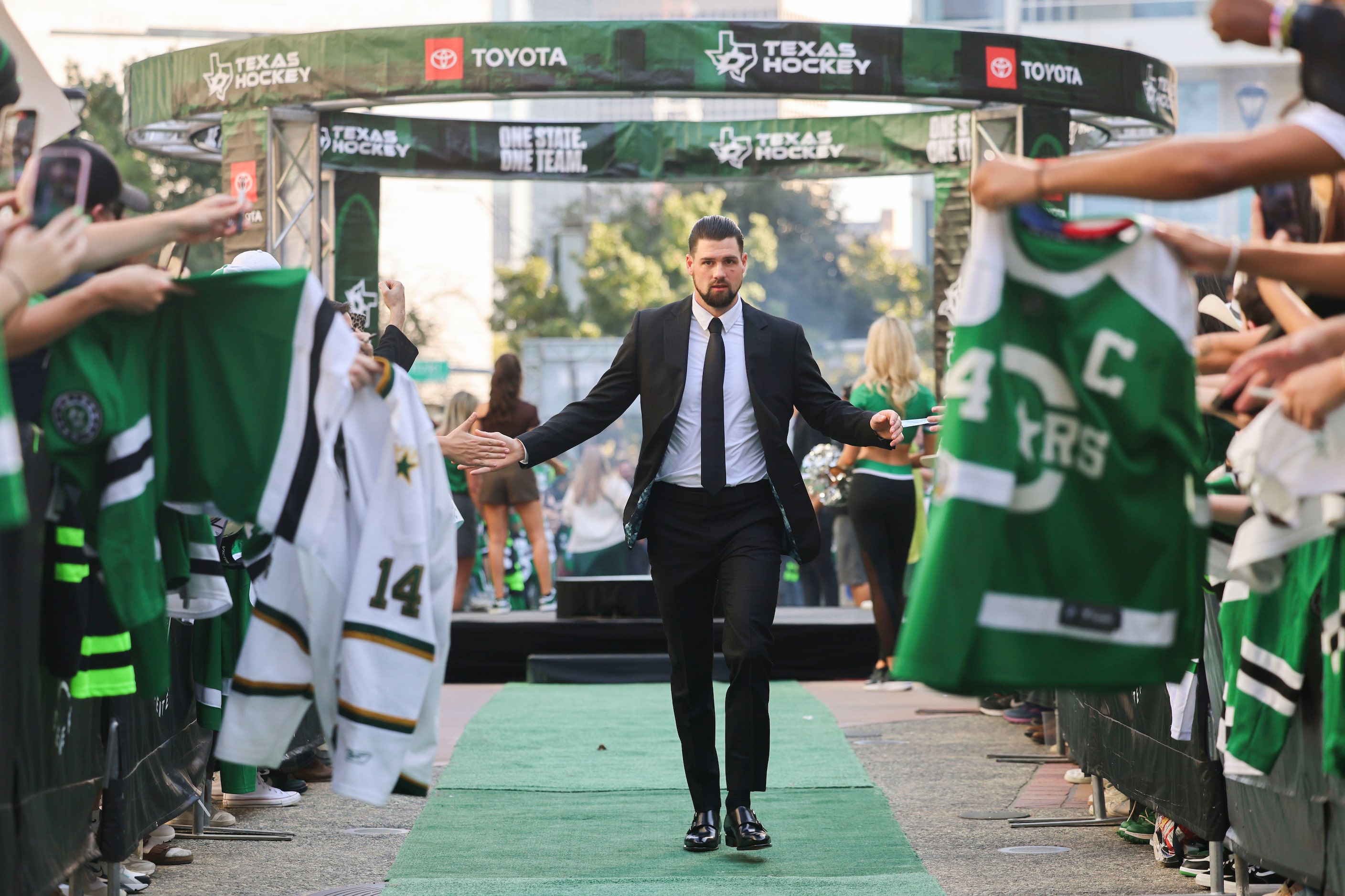 Dallas Stars left wing Jamie Benn high fives fans as he makes his way during the team’s home...