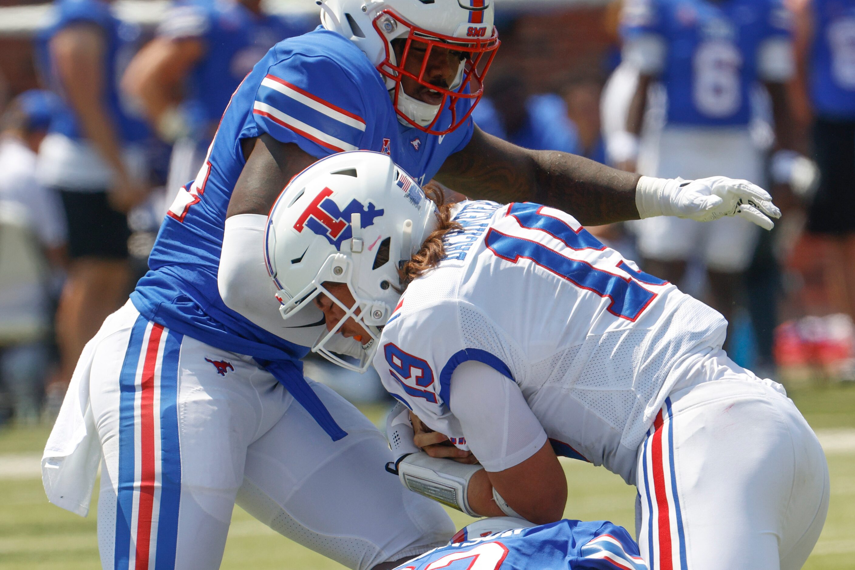 Southern Methodist linebacker Kobe Wilson (back) blocks Louisiana Tech quarterback Hank...