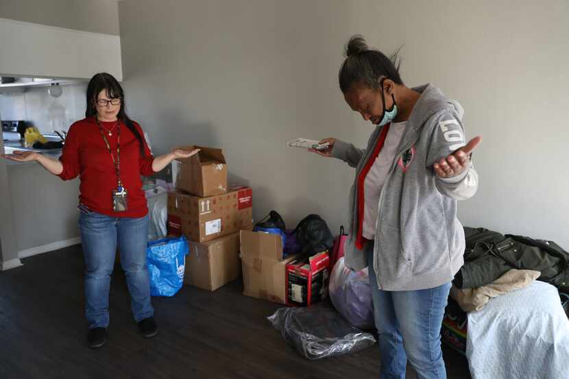 Faith Bartes (left), staff member at The Bridge Homeless Recovery Center, leads Patricia...