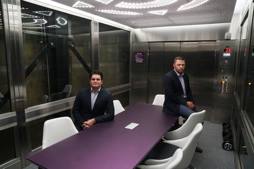 Purple Land Management owners Bryan Cortney and Jesse Hejny show off their funky elevator...