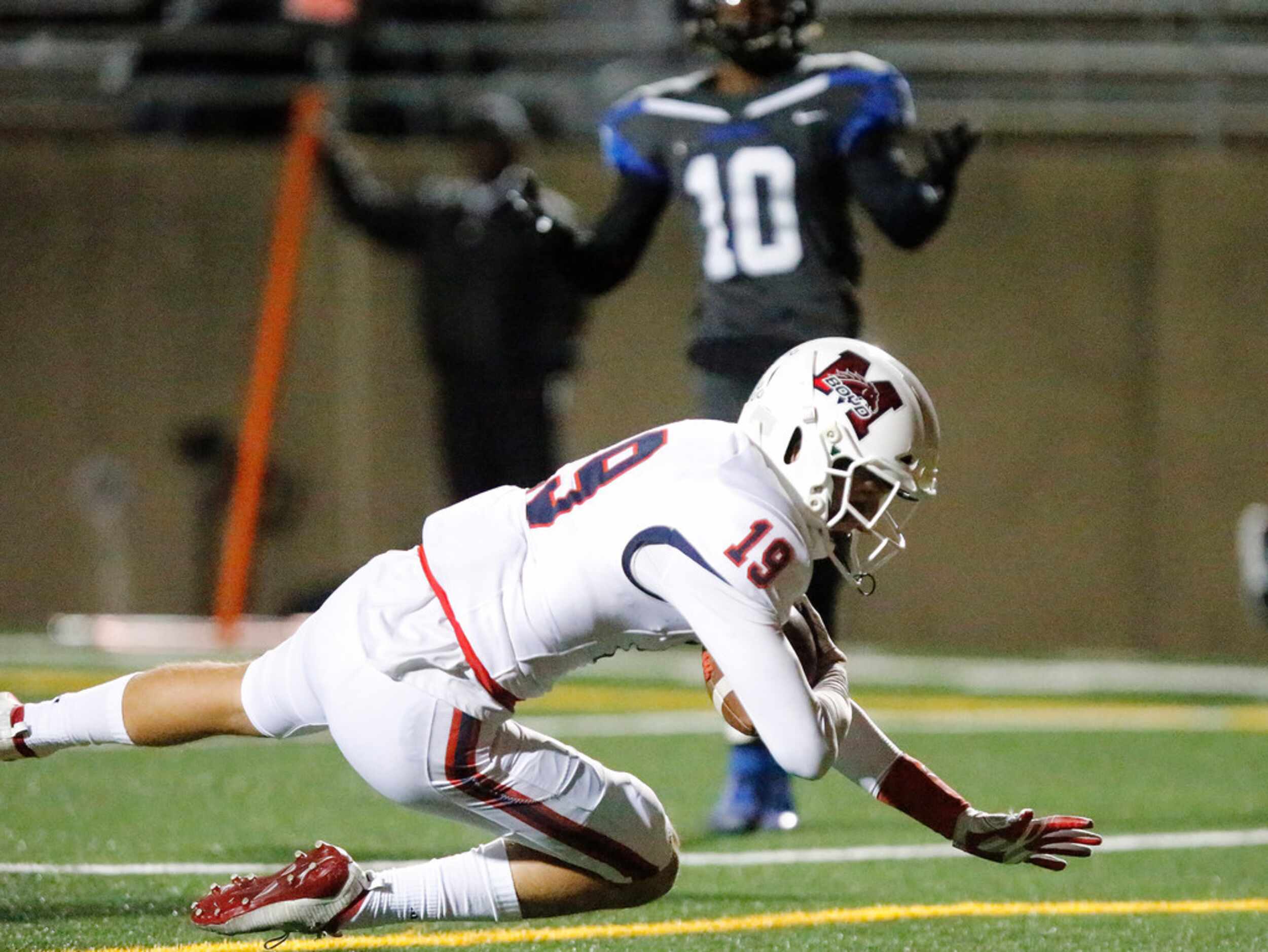 McKinney Boyd High School wide receiver Jack Hagan (19)  falls to the ground in the end zone...