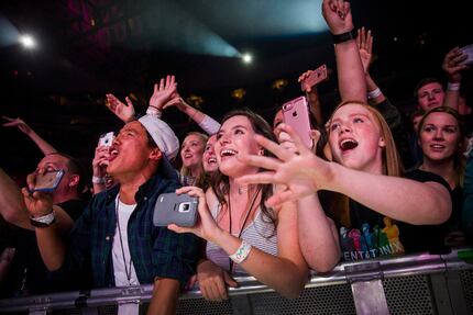 Audience members cheer as Pentatonix performs at the American Airlines Center on Sunday,...