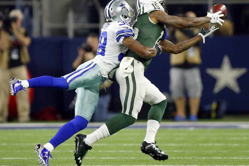 Dallas Cowboys cornerback Brandon Carr (39) breaks up a pass thrown to New York Jets wide...