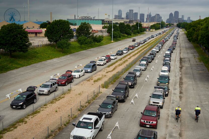 Cars lined up for distributions from the North Texas Food Bank at Fair Park on May 14. The...