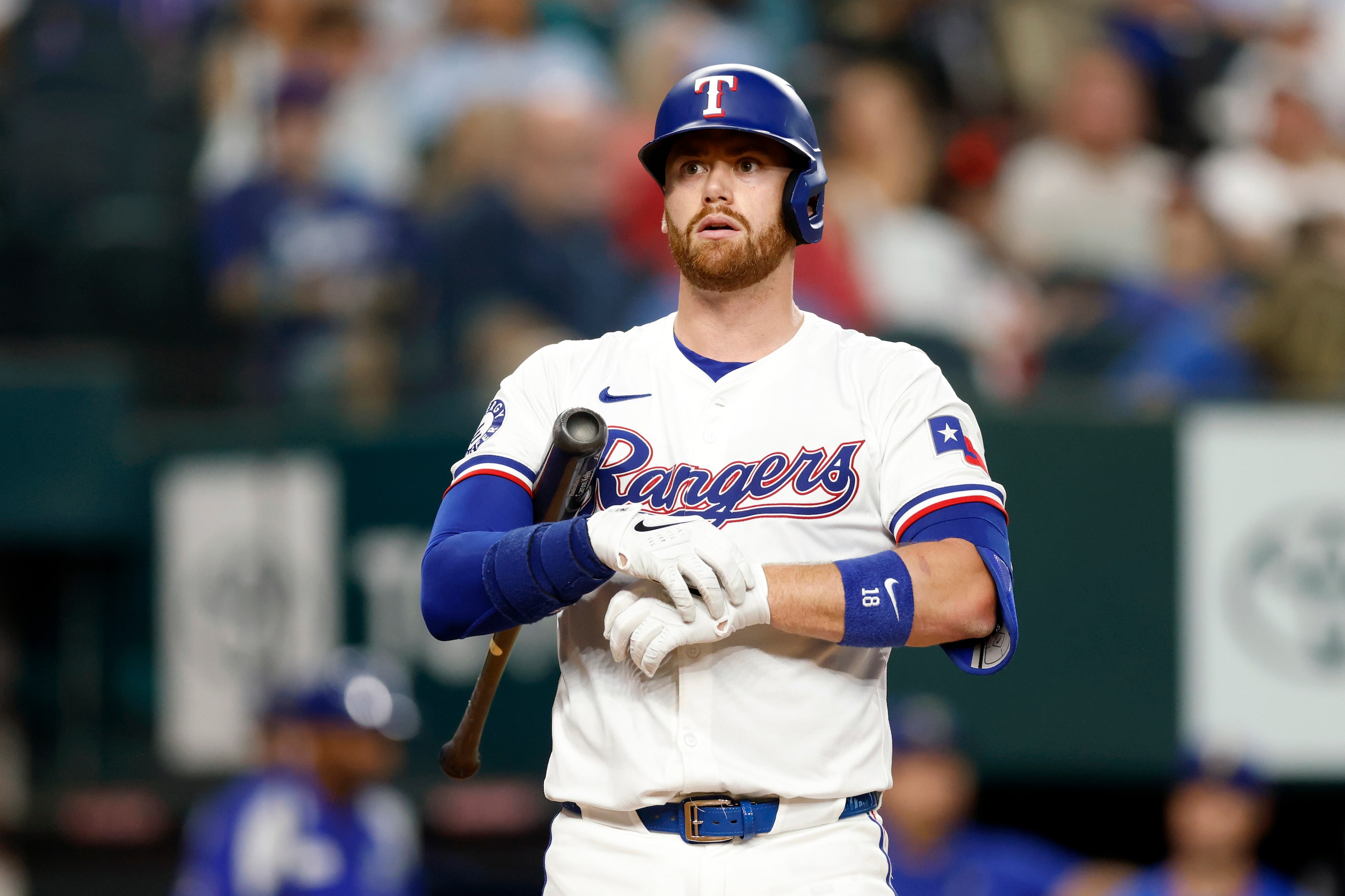 Texas Rangers catcher Carson Kelly (18) adjusts his gloves during an at bat in the third...