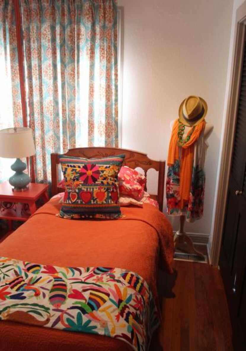 
The guest bedroom is bright with enthnic textiles. 
