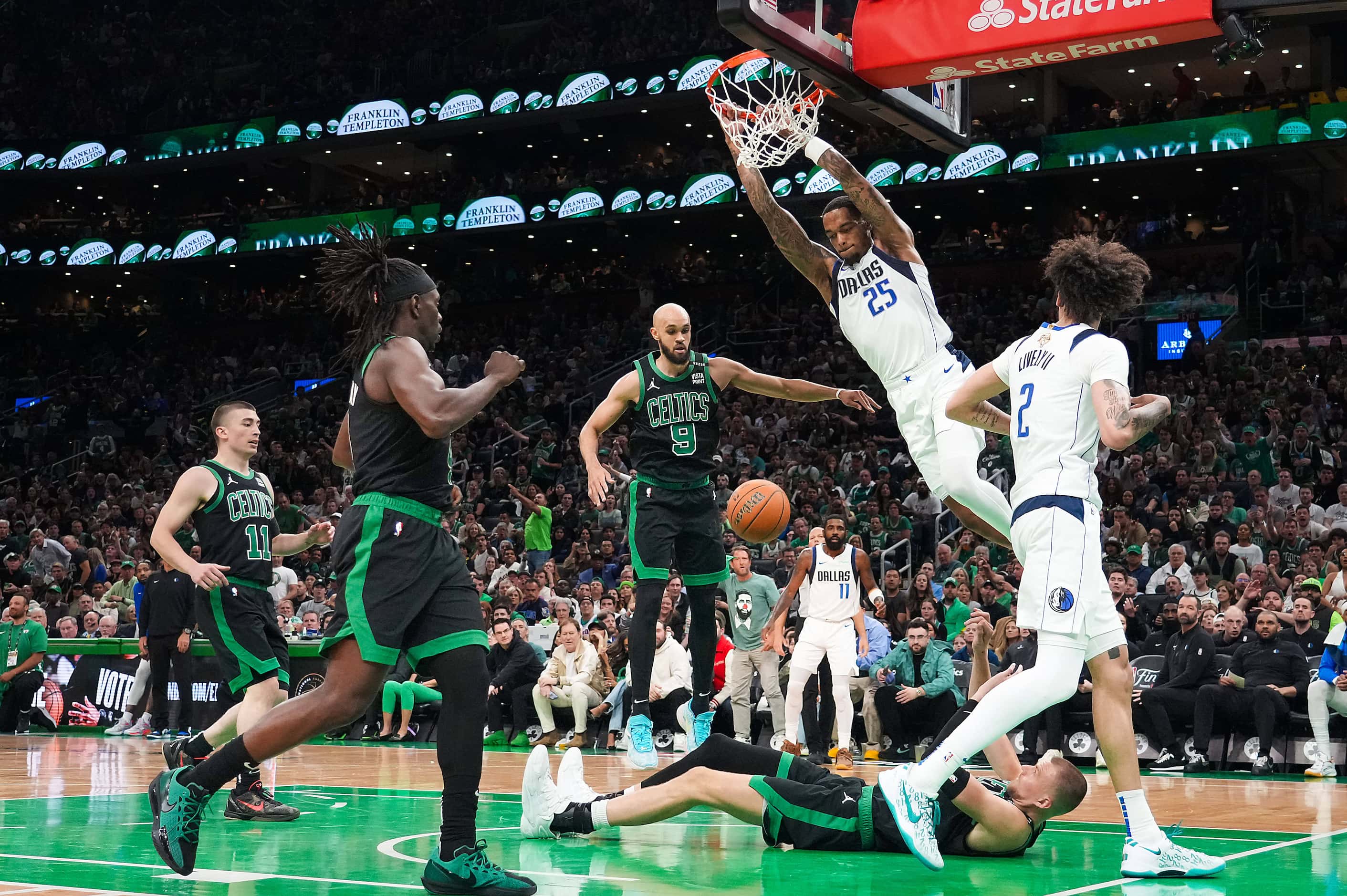 Dallas Mavericks forward P.J. Washington (25) dunks the ball over Boston Celtics center...