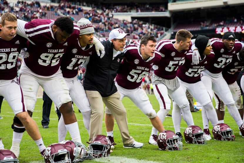 FILE - Texas A&M head coach Jimbo Fisher and his players celebrate a win over Ole Miss on...