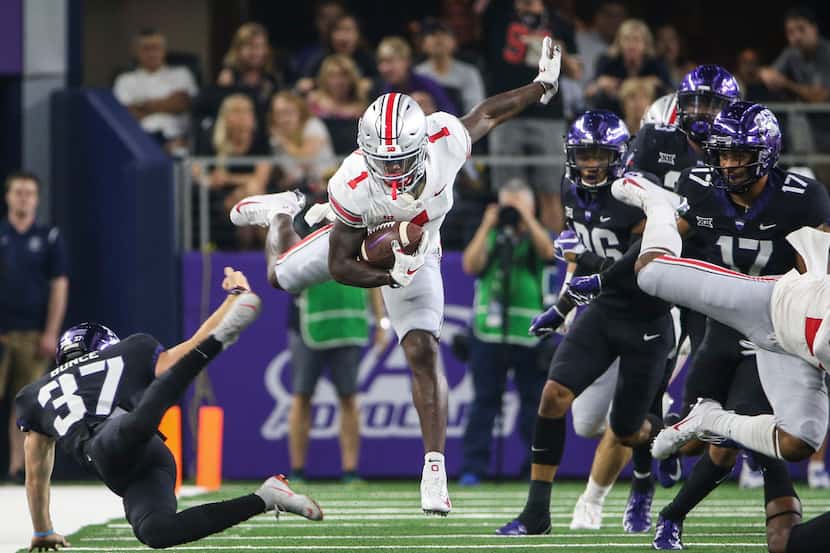 Ohio State Buckeyes wide receiver Johnnie Dixon (1) attempts to navigate past TCU defense...