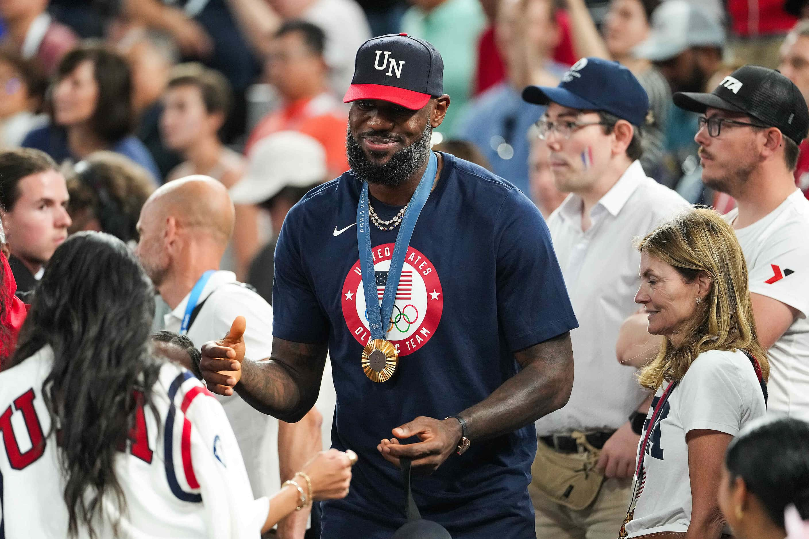 LeBron James wears his gold medal as he arrives to watch the women’s gold medal basketball...