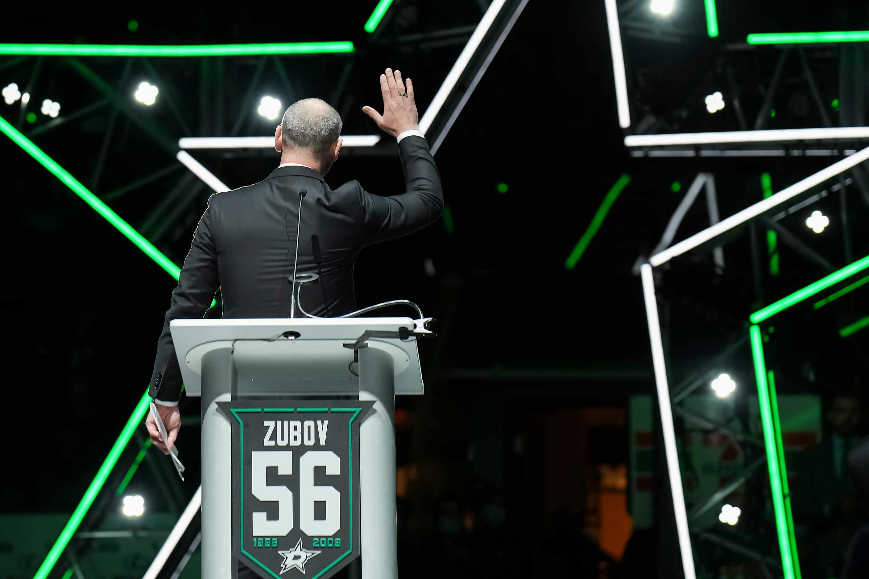 Former Dallas Stars player Sergei Zubov waves to the crowd during ceremonies for his jersey...