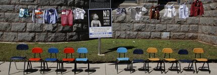  Chairs and articles of clothing outside the Old Red Courthouse memorialize Dallas County...