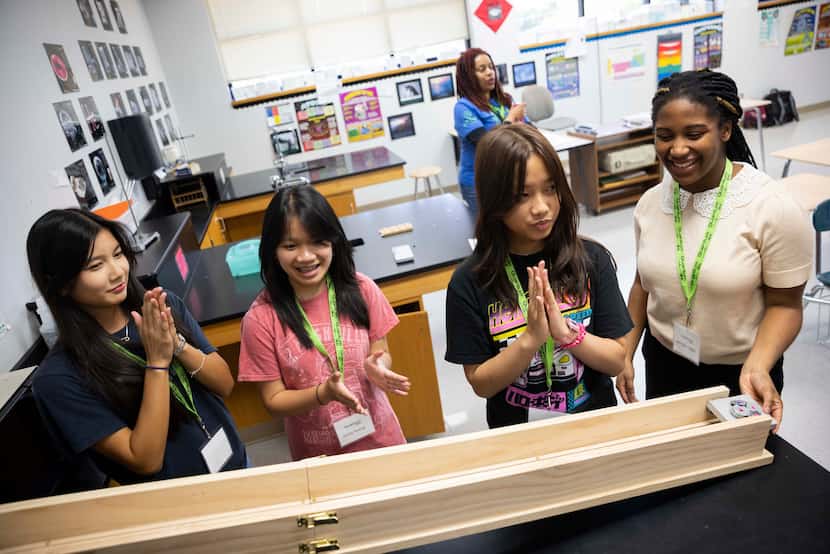 (From left) Students Cate Nguyen, Emily Hoang, Davy Huynh and Jennifer Udoh clap after their...