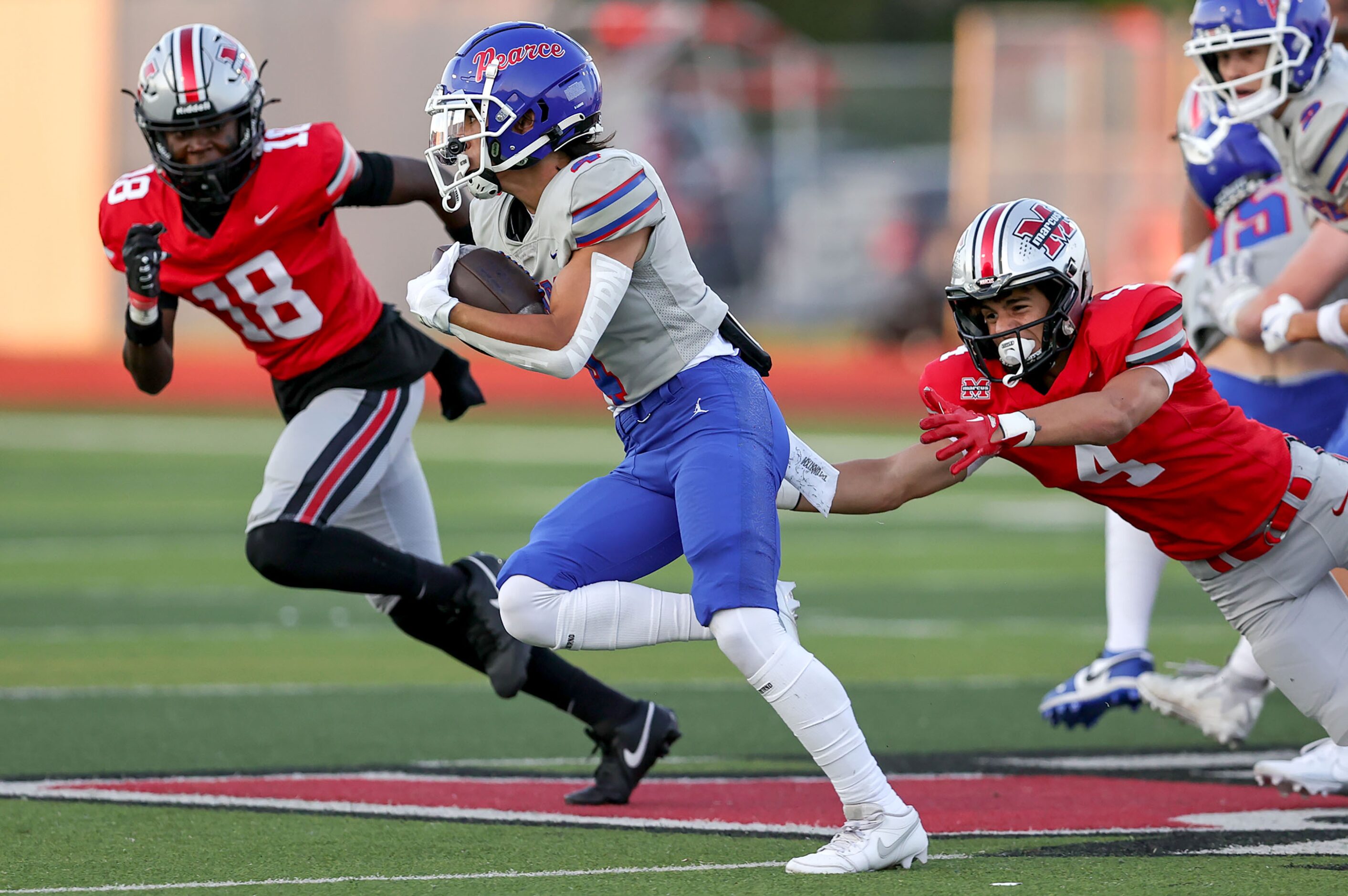 Richardson Pearce running back Andrew Casegrande (4) tries to get past Flower Mound Marcus...