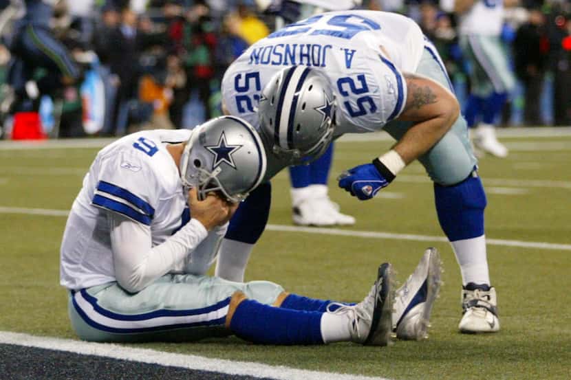 Tony Romo holds his head after he bobbled a snap on a field goal attempts  with 1:19 left in...
