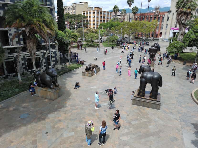 People walk past sculptures by Colombian artist Fernando Botero at Botero Park in Medellin,...