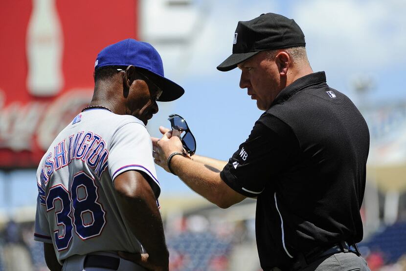 Jun 1, 2014; Washington, DC, USA; Umpire Jeff Nelson explains a call to Texas Rangers...