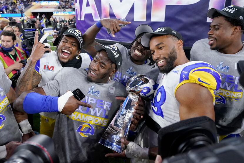 FILE - Los Angeles Rams players celebrate with the Lombardi Trophy after defeating the...