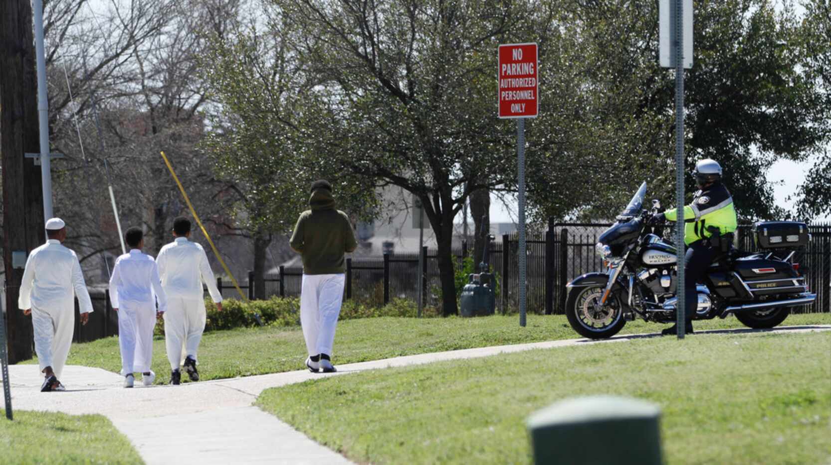 A family heads toward the Islamic Center of Irving for afternoon prayers as an Irving...