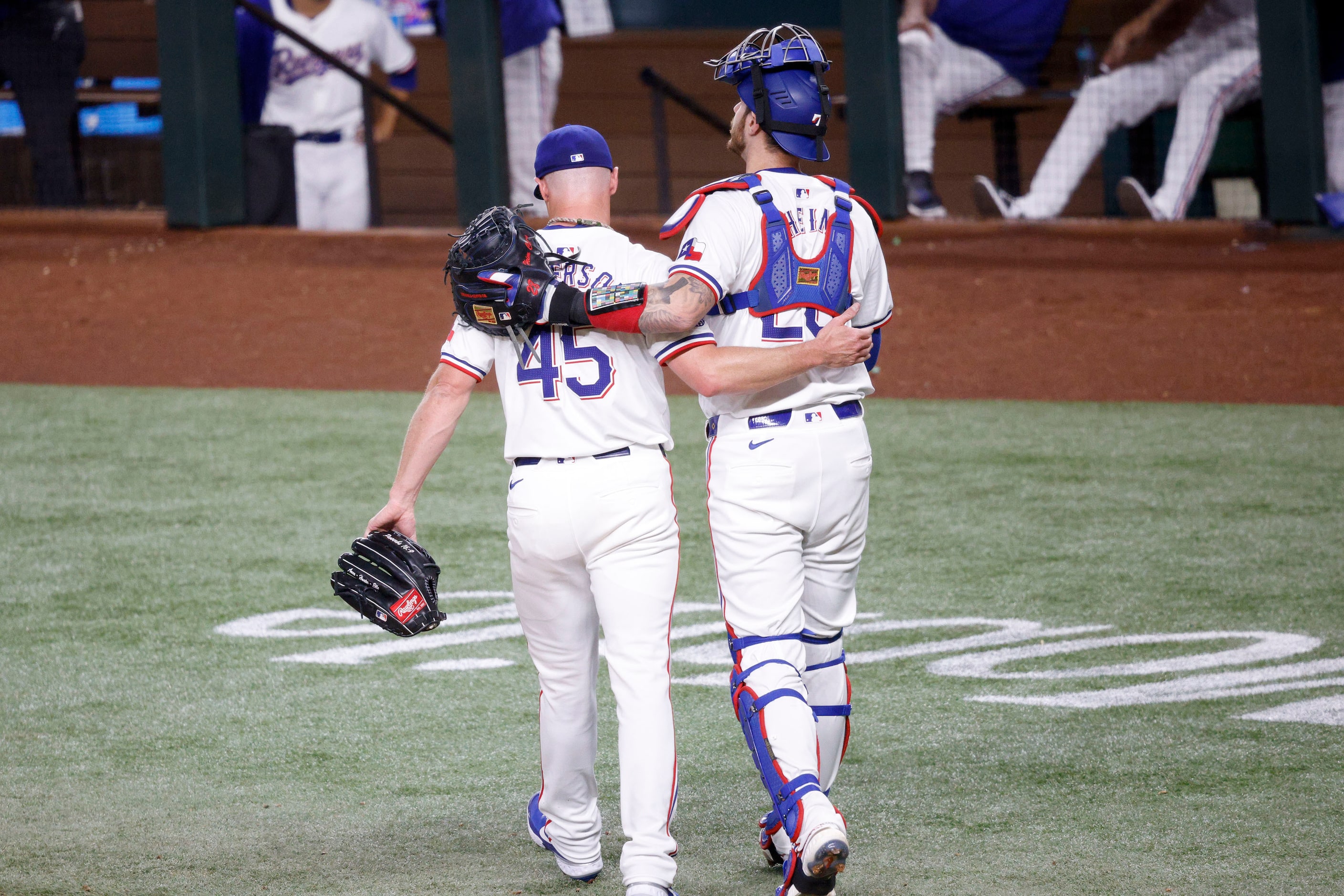 Texas Rangers pitcher Chase Anderson (45) leaves a field with Texas Rangers catcher Jonah...