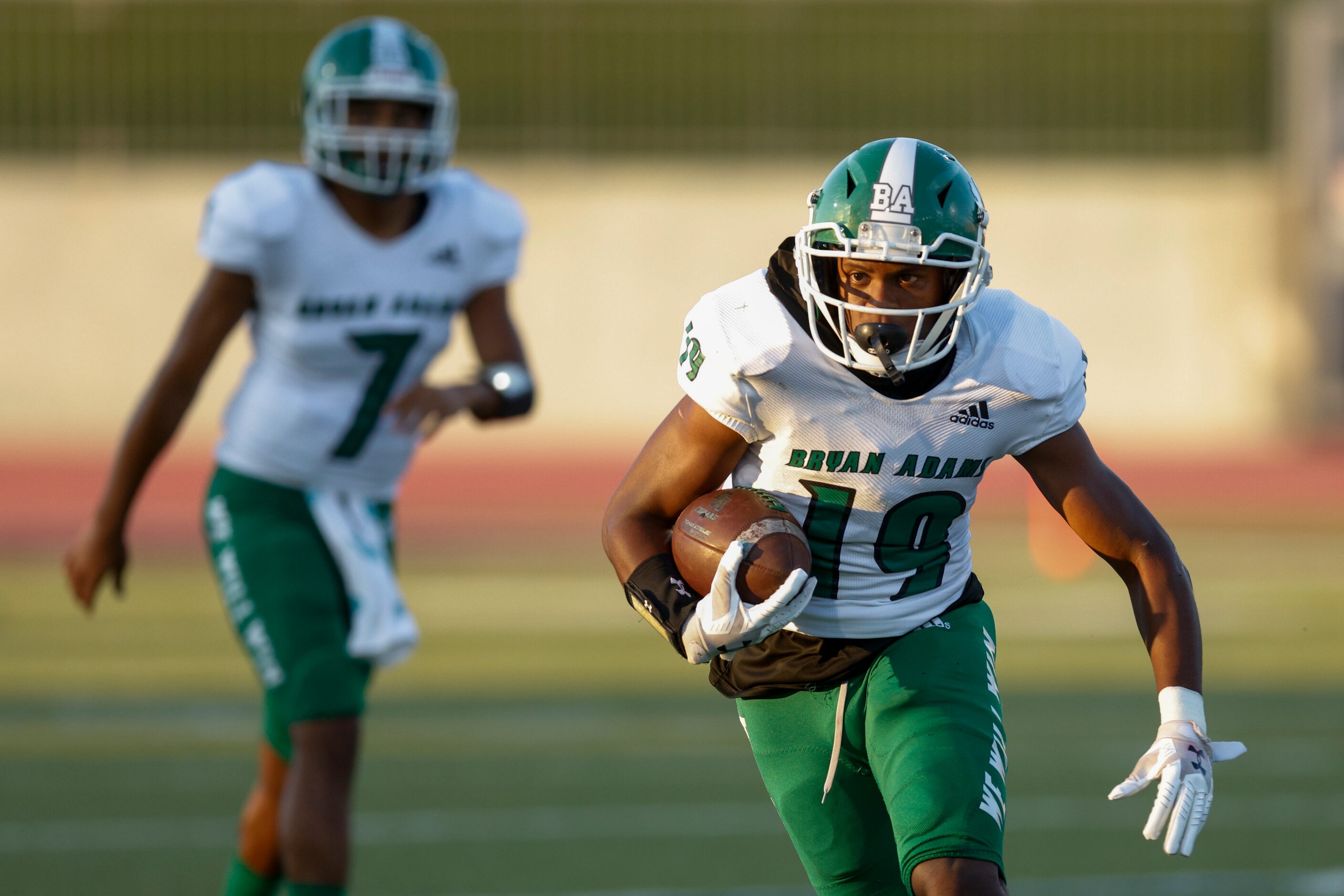 Bryan Adams running back Jon’Trevious Nunn (19) runs the ball after taking the hand-off from...