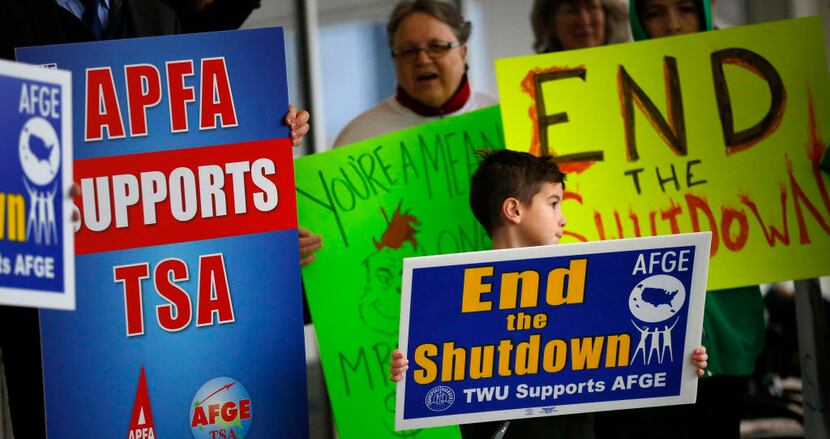 Airport employees and their families protest the government shutdown on Jan. 16 outside of...
