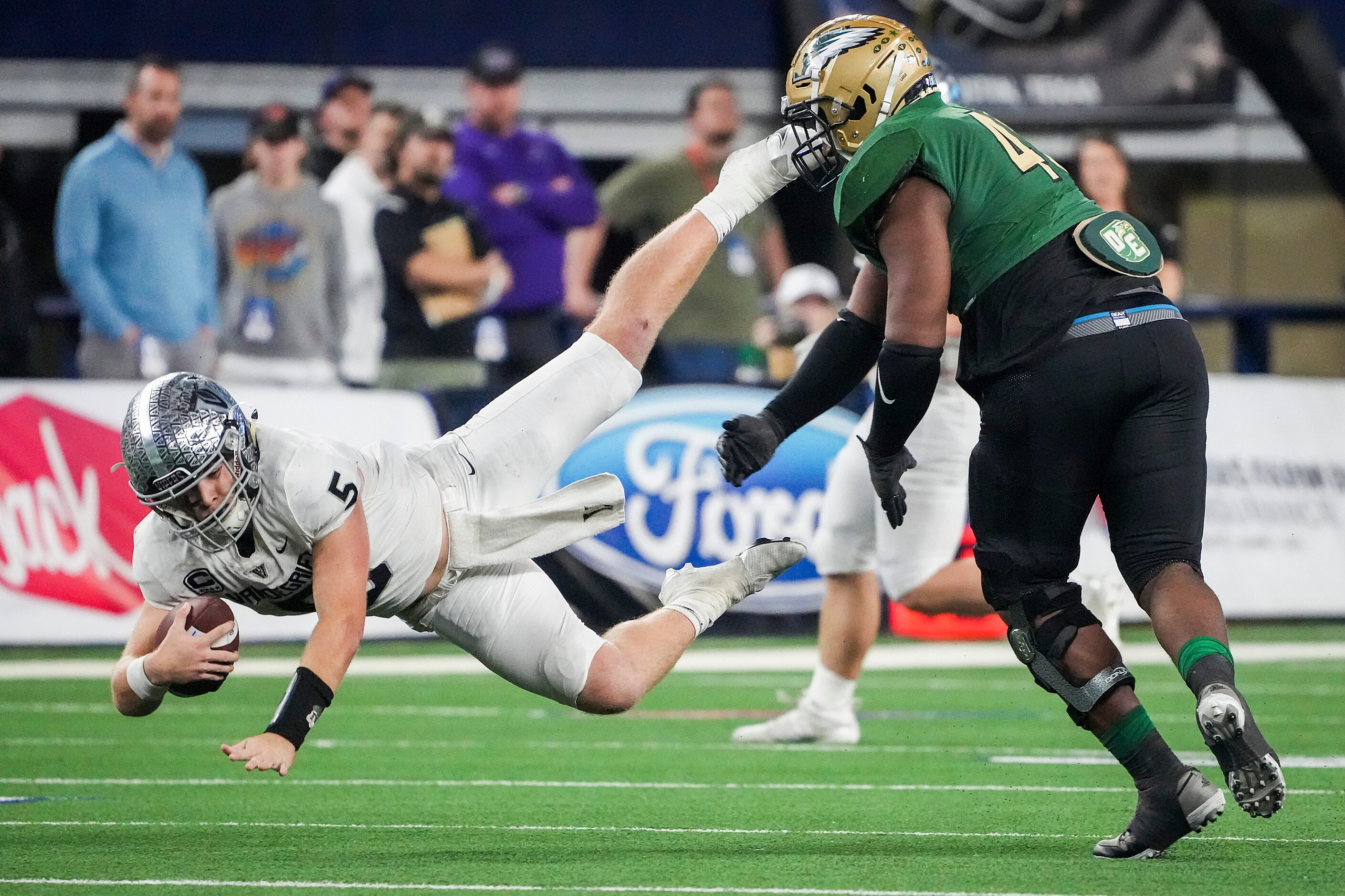 Austin Vandegrift quarterback Brayden Buchanan (5) is sacked by DeSoto defensive lineman...