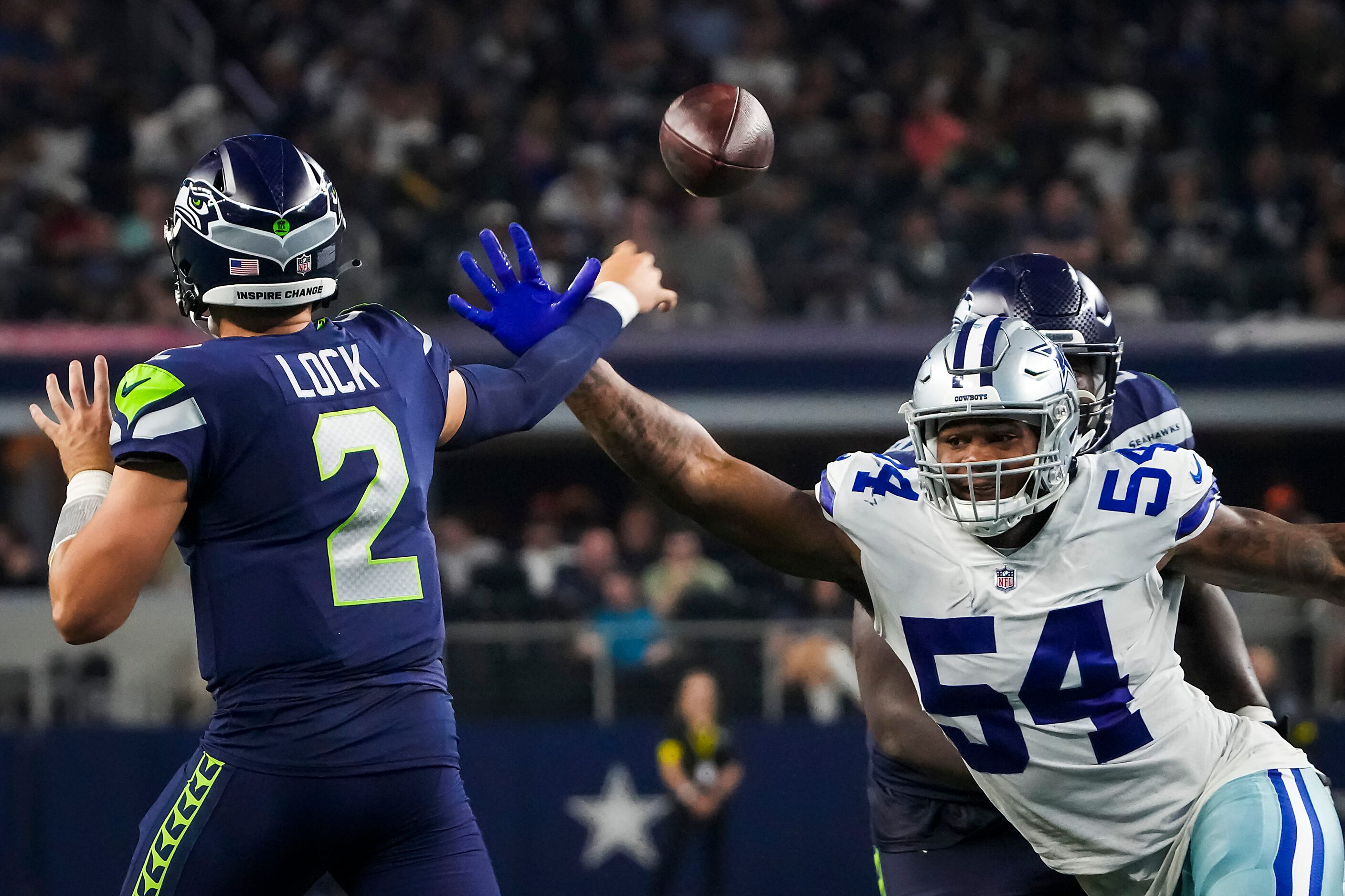 Seattle Seahawks quarterback Drew Lock (2) gets off a pass under pressure from Dallas...