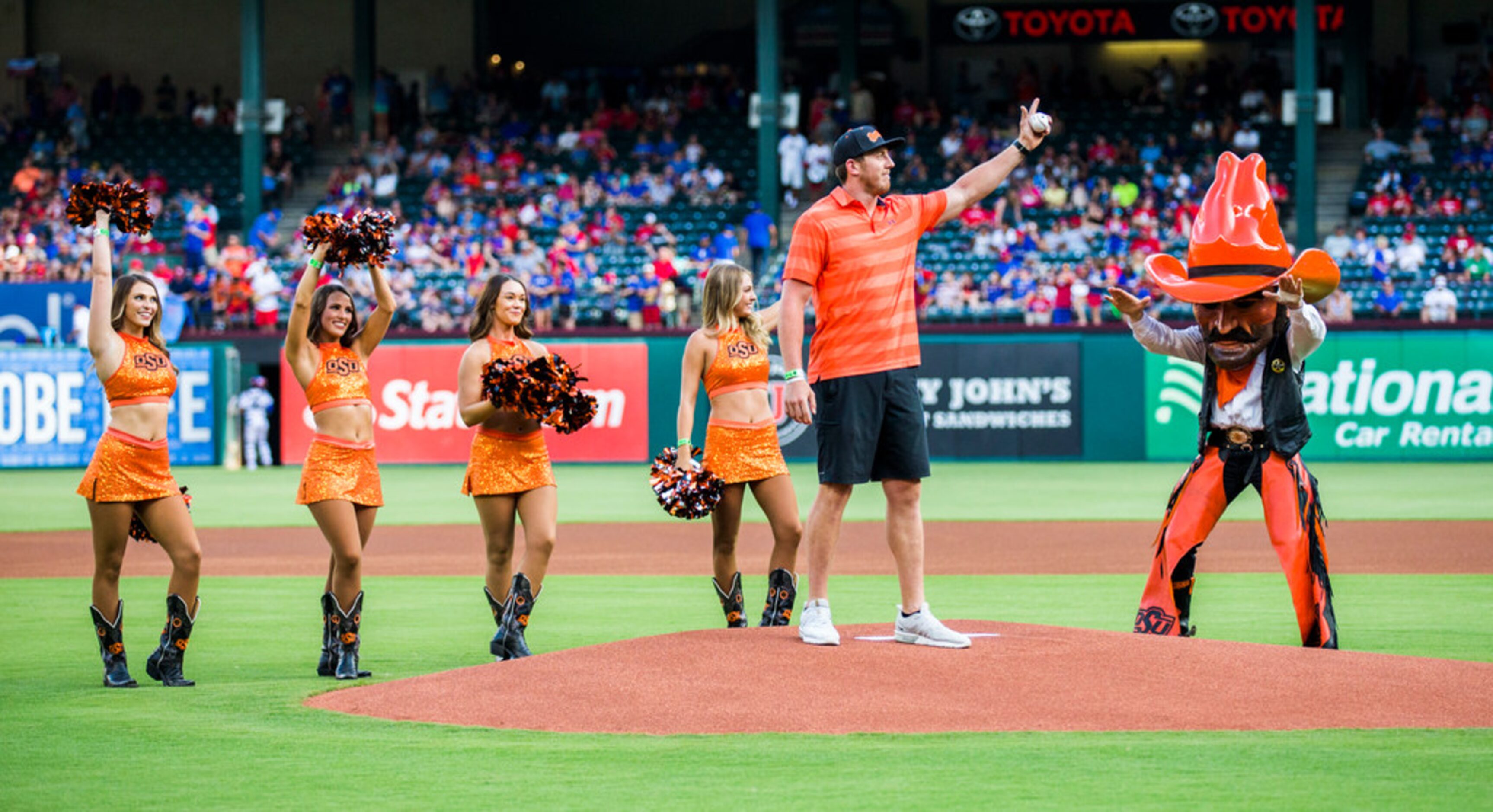 Dallas Cowboys tight end Blake Jarwin throws out the first pitch before an MLB game between...