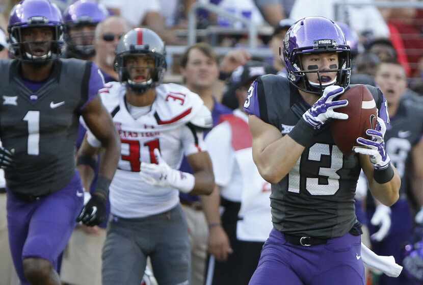 TCU receiver Ty Slanina (13) catches a third-quarter aerial and turns it into a touchdown as...