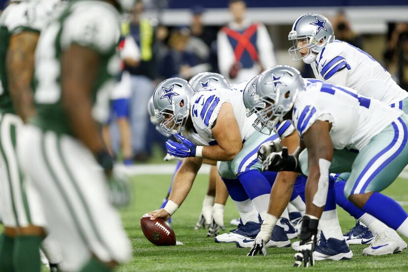 Dallas Cowboys quarterback Kellen Moore (17) prepares to take the snap as the offensive line...