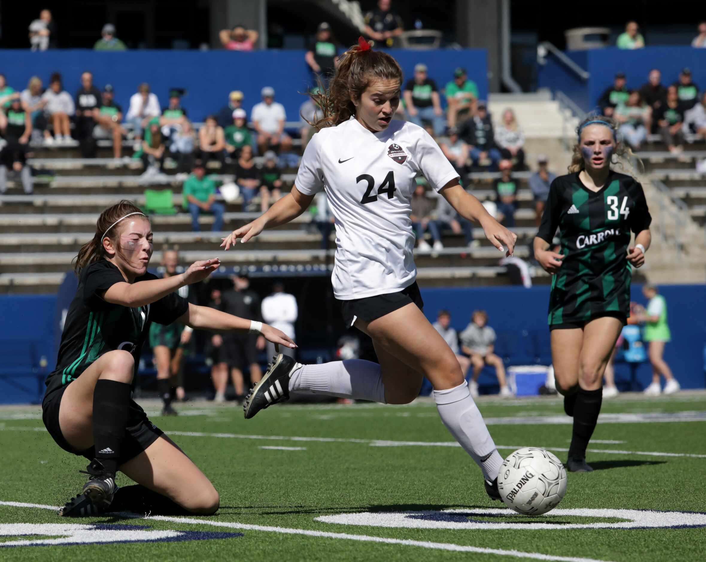 Mound Marcus player #24, Lyndi Maxson, goes up against Southlake Carroll Flower player #12,...