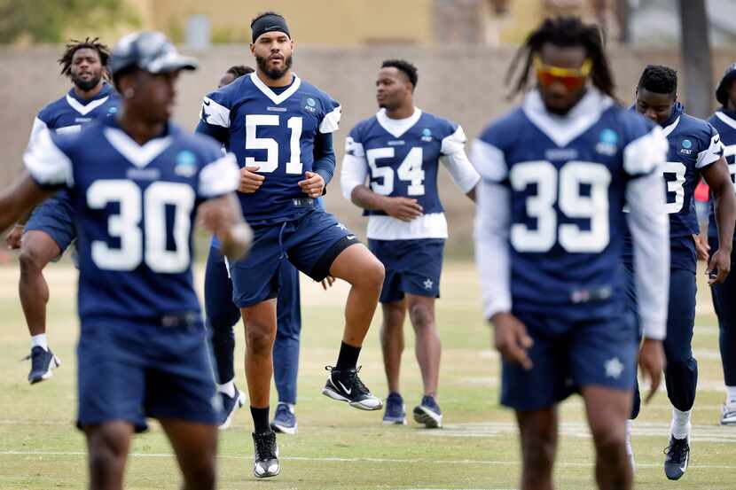 New Dallas Cowboys linebacker Anthony Barr (51) stretches with teammates during the NFL...