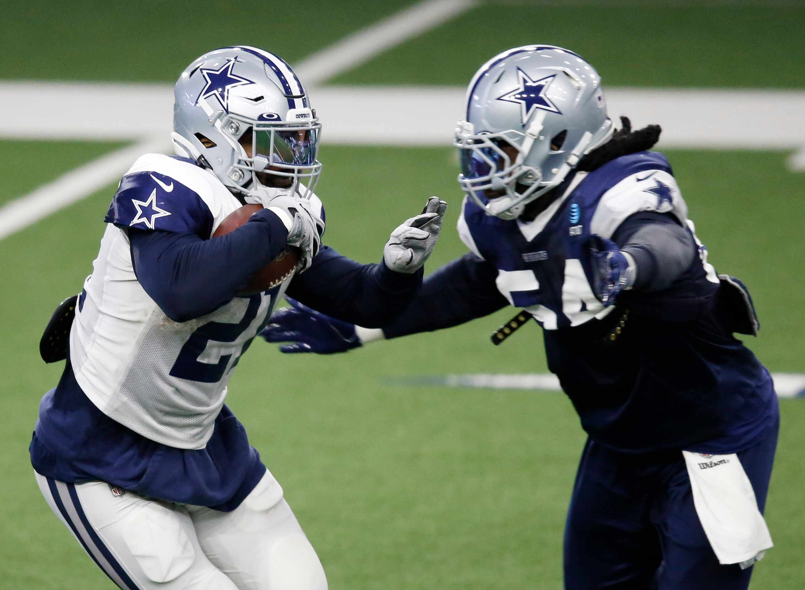 Dallas Cowboys running back Ezekiel Elliott (21) is tackled by Dallas Cowboys linebacker...