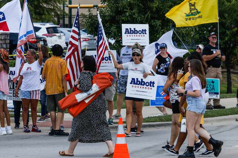 Supporters of Texas Gov. Greg Abbott gathered outside the Frisco venue where his Democratic...