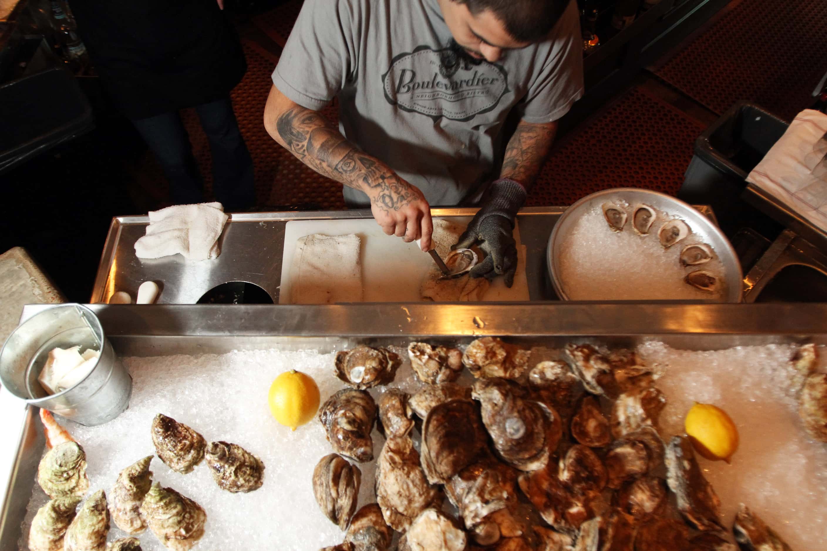 Oyster shucker Arthur Burnett prepares oysters at Boulevardier in Dallas in 2012.