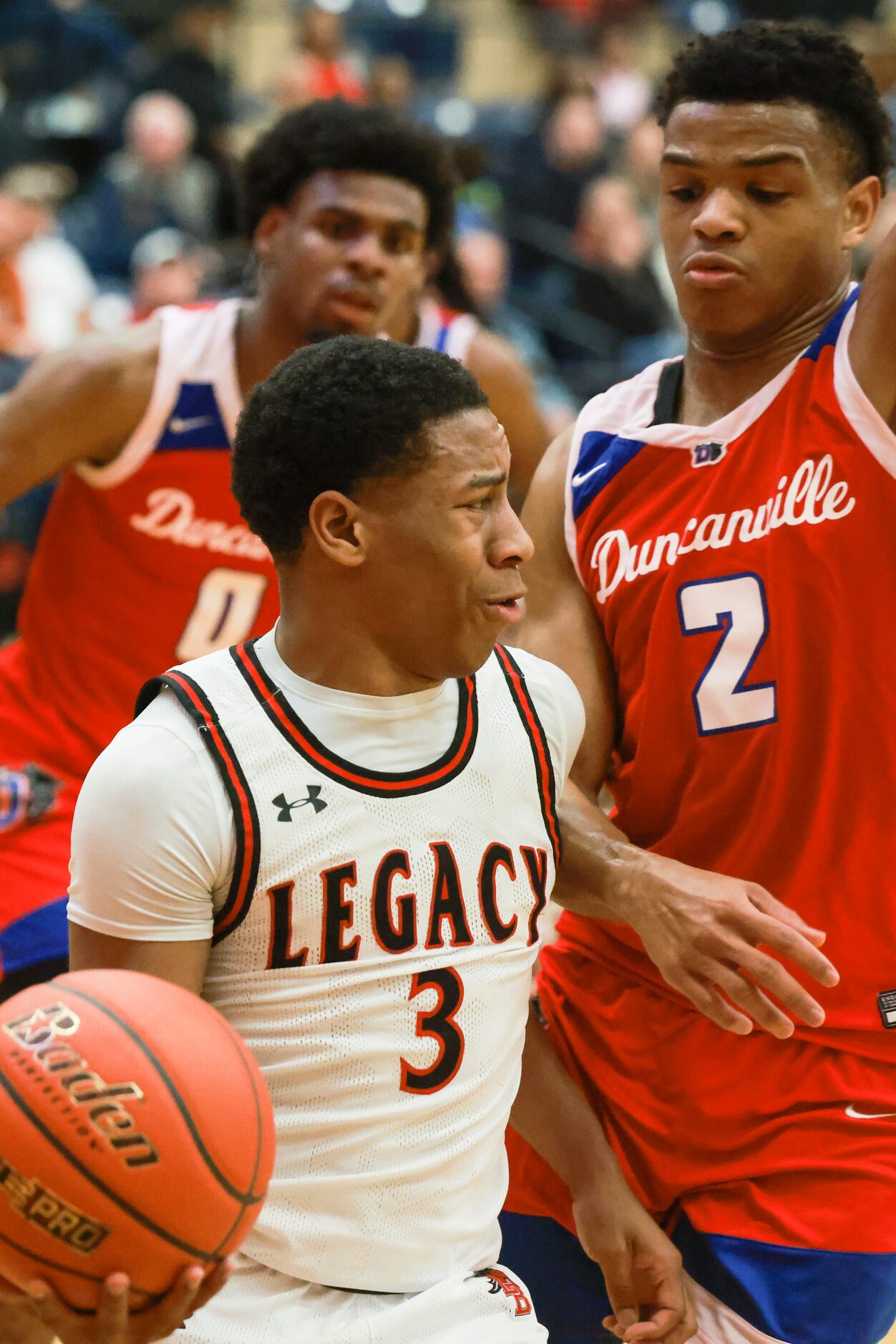 Mansfield Legacy High School’s Jhaden Brown (3) pushes past Duncanville High School’s Evan...