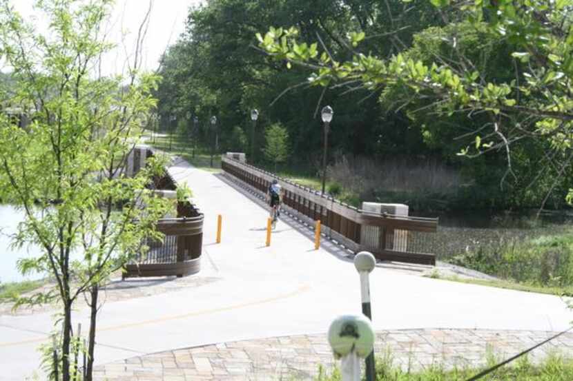 
Cyclists pass each other on the White Rock Creek Trail below Abrams Road, on April 27. The...