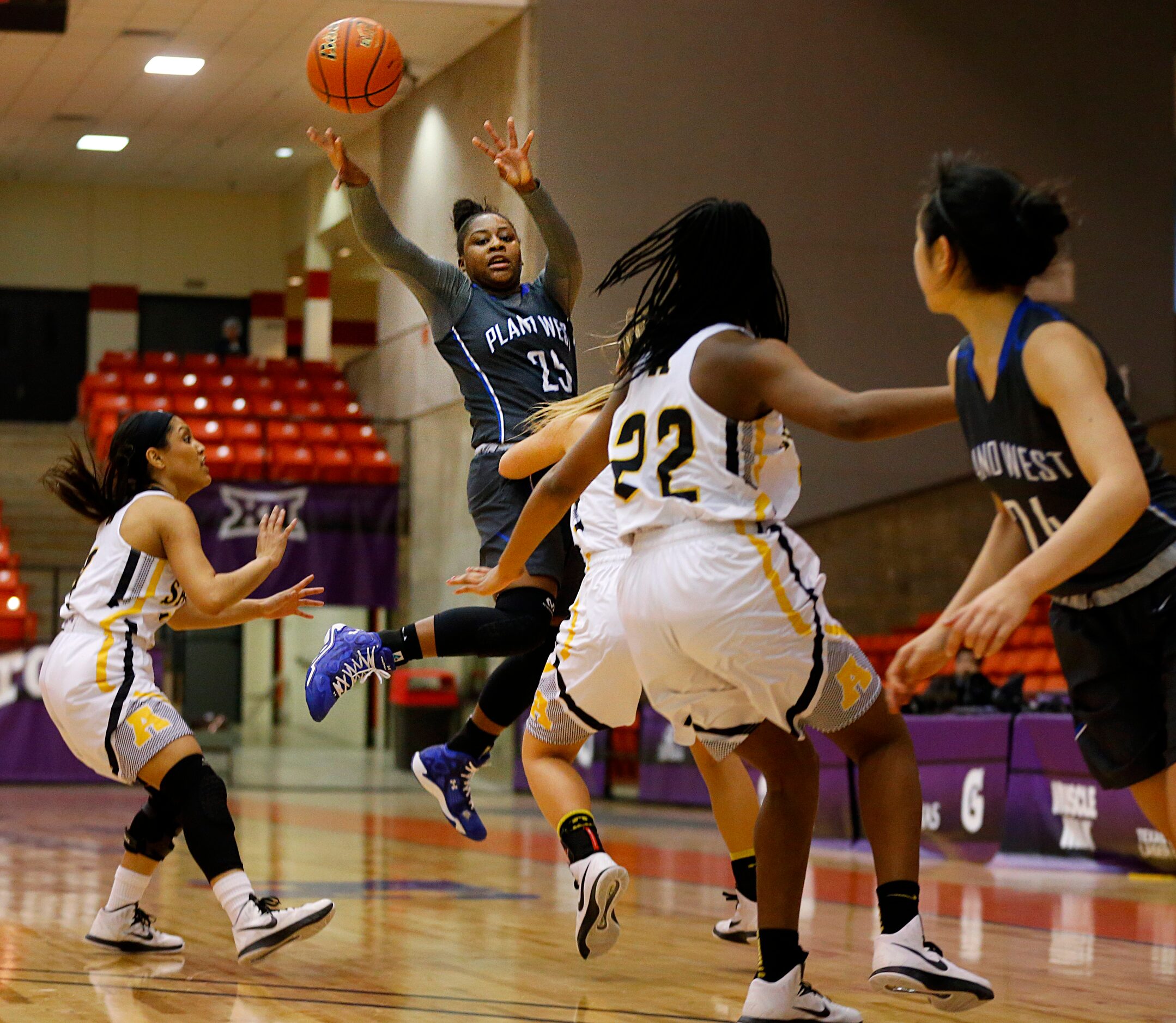 Plano West Sydney Skinner (25) passes the ball to teammate Natalie Chou (24) as she was...