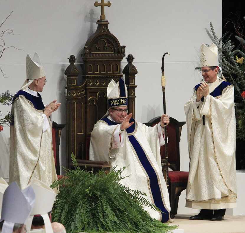 Fort Worth Bishop Michael Olson (center, shown at his 2014 ordination) said through a...