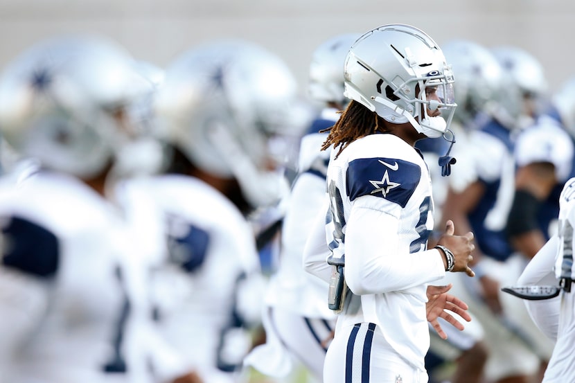 Dallas Cowboys wide receiver CeeDee Lamb (88) stretches with teammates in practice during...