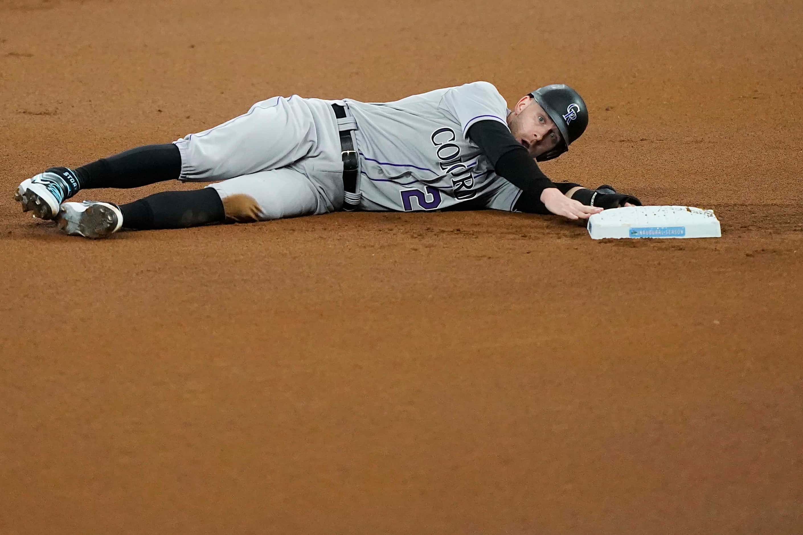 Colorado Rockies shortstop Trevor Story reacts after being tagged out at second base on a...