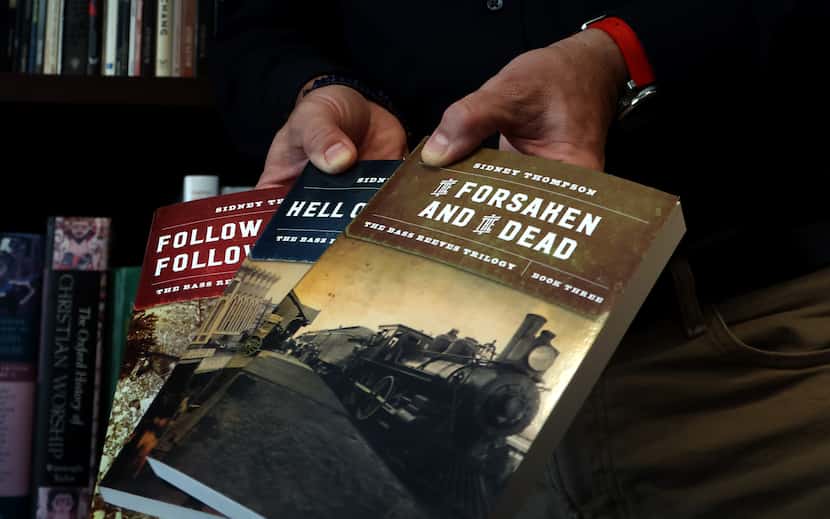 Sidney Thompson holds three books he authored of the Bass Reeves Trilogy, two of which have...