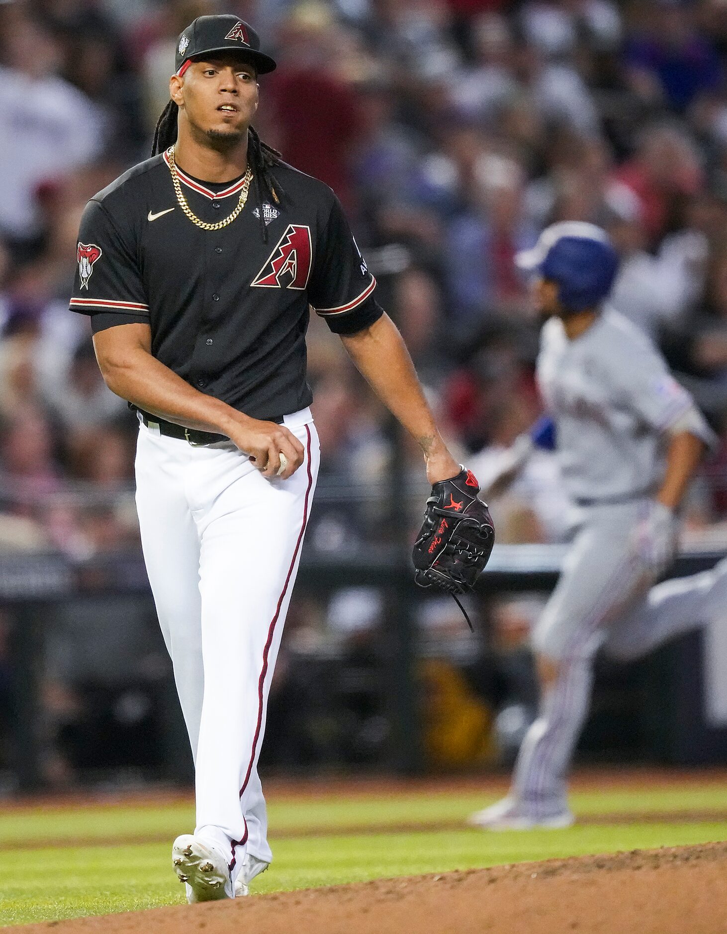 Arizona Diamondbacks pitcher Luis Frias reacts after a three-run home run by Texas Rangers...