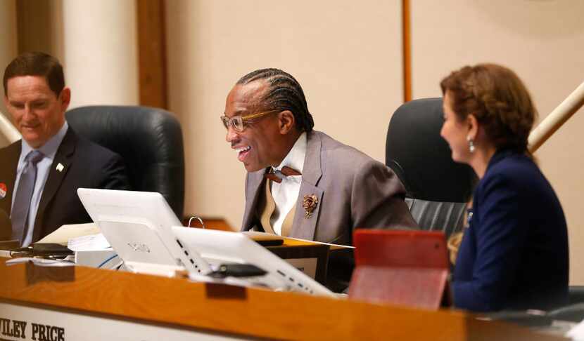 Dallas County Commissioner John Wiley Price (center) smiles while speaking next to County...