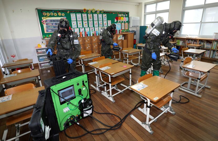 South Korean army soldiers sprayed disinfectant to help reduce the spread of the new...