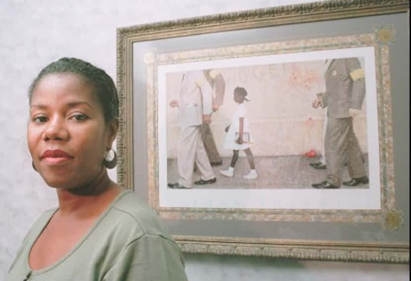 Ruby Bridges Hall poses Aug. 28, 1995, next to a print of the Norman Rockwell painting that...