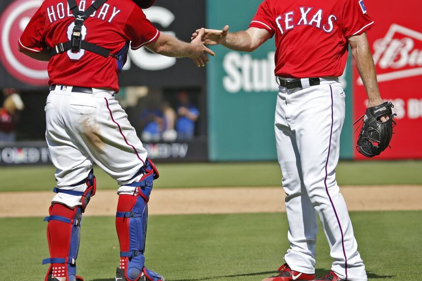 Texas Rangers catcher Bryan Holaday (8) congratulates Texas Rangers relief pitcher Sam Dyson...